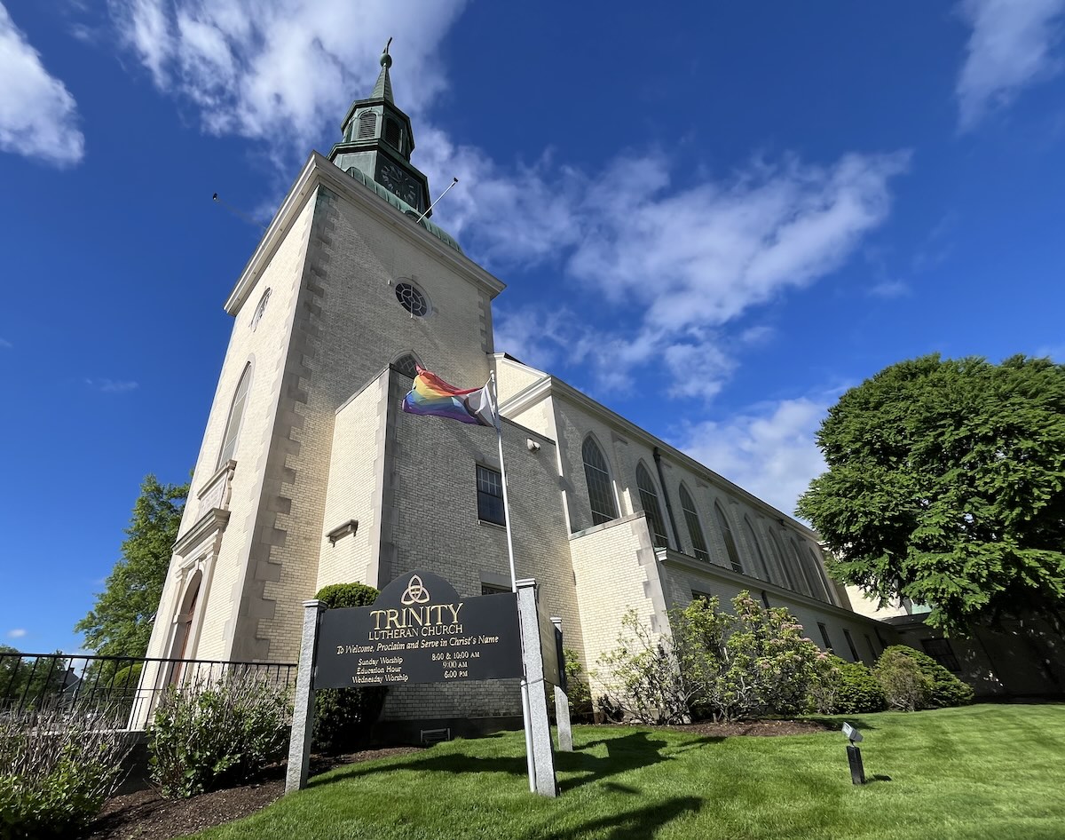 Exterior of the church, including rainbow pride flag.